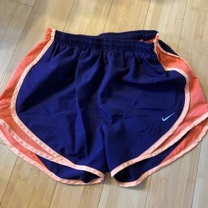 Women’s tangerine and purple Nike shorts